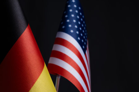 Flags Germany and United States on black background.