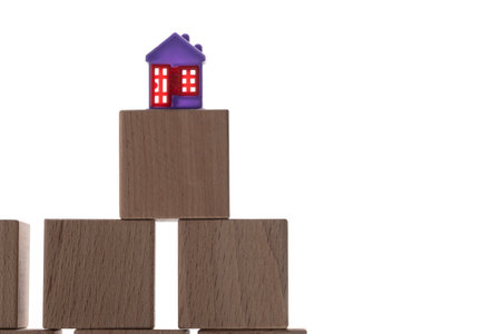 House model on wooden blocks isolated on white background with copy space.