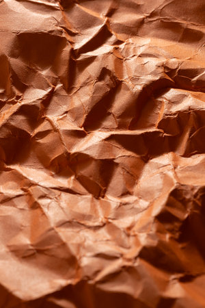 Crumpled orange paper as  background. Close up image.の写真素材