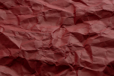 Crumpled red paper as background. Close up.の写真素材
