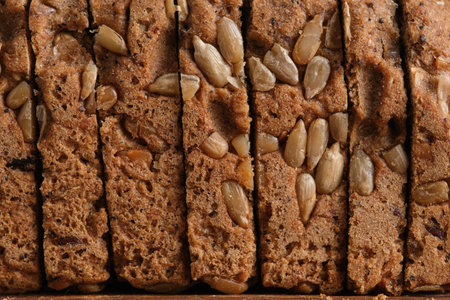 Slices of delicious homemade bread with sunflower seeds, closeup