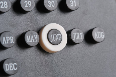 Month June on stylish black calendar.