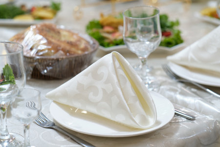 Table set for an event party or wedding reception. Plates and cutlery on table.の写真素材