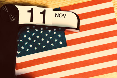 Flag  United States  America,  desktop calendar with   date November 11 on  blue background. Veterans Day.の写真素材