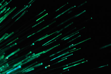 abstract background with green optical fibres dinamic flying from deep on black
