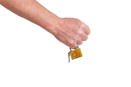 Hand holding a key, isolated on white background with clipping path.