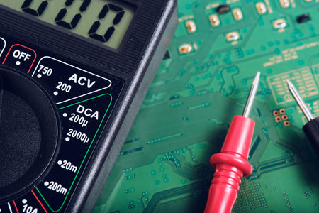 Digital multimeter on a printed circuit board close-up macro photography