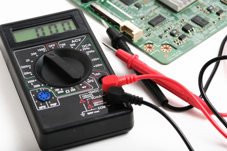 Digital multimeter with multimeter on white background, close-up