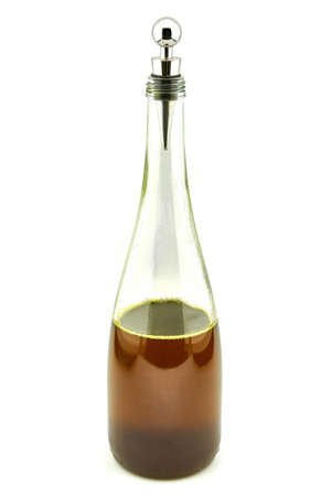 glass bottle with soybean oil on a white background metal plugの写真素材