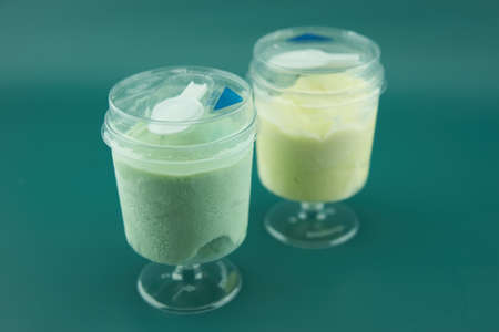 two plastic glasses with ice cream closeupの写真素材