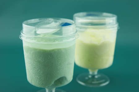 two plastic glasses with ice cream closeupの写真素材