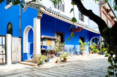 Door, Cart and bicycle side view through the arch at Cheong Fatt Tze Mansion.の写真素材