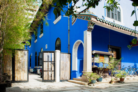 Looking through blue mansion from the shades of tree and bamboos at Cheong Fatt Tze Mansion.の写真素材