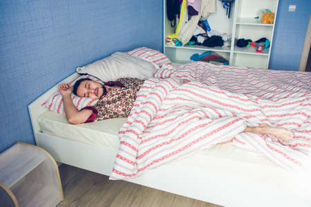 men's bedroom with a bed in sleeping manの写真素材