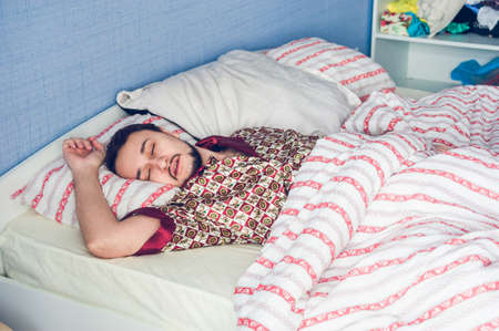 a man fast asleep with his mouth openの写真素材