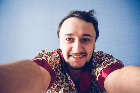 man smiles and makes the morning selfieの写真素材