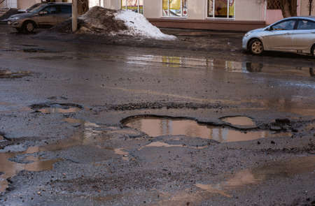 there are many potholes on the roadwayの写真素材