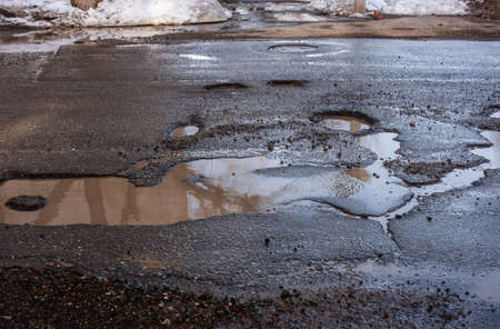 bad surface on the roadway in the cityの写真素材