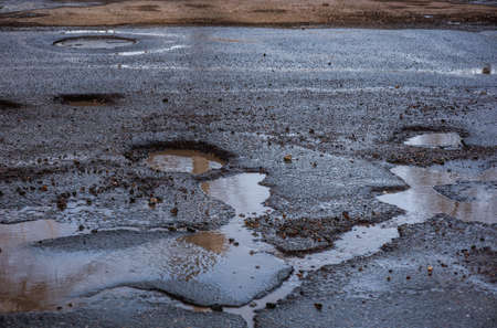 there are many potholes on the roadwayの写真素材