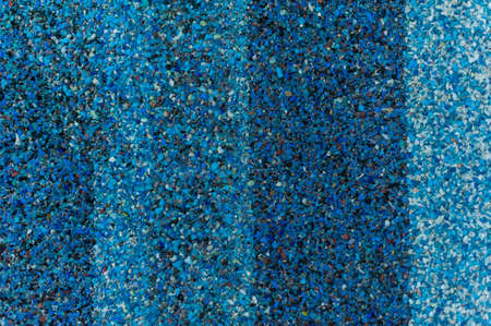 bright blue texture of small stone chips with a gradientの写真素材