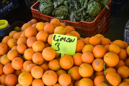 fresh tangerines and lemons on a street marketの写真素材