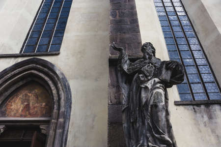 Ancient sculpture near the entrance to the Catholic Churchの写真素材