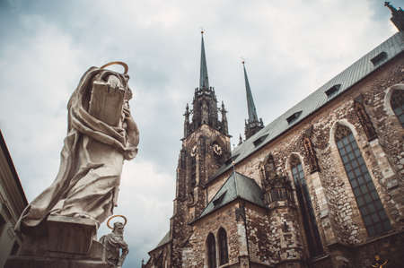 Bottom view on the Church of St. Peter and Paul in Brno and sculptures of saints on sky backgroundの写真素材