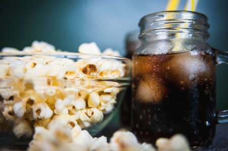 misted bottles of Cola with ice and fresh kettle cornの写真素材