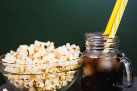 misted bottles of Cola with ice and fresh kettle cornの写真素材
