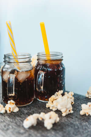 misted bottles of Cola with ice and fresh kettle cornの写真素材