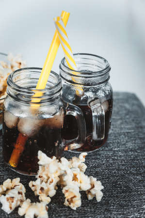 misted bottles of Cola with ice and fresh kettle cornの写真素材