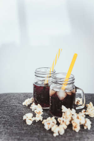 misted bottles of Cola with ice and fresh kettle cornの写真素材