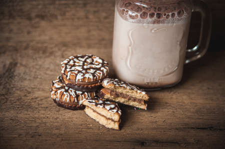 Cookies with chocolate and a bottle of warm cocoa. Autumn backgroundの写真素材