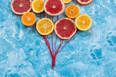 Orange, tangerine and grapefruit in conjunction as balloonsの写真素材