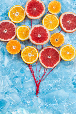 Orange, tangerine and grapefruit in conjunction as balloonsの写真素材