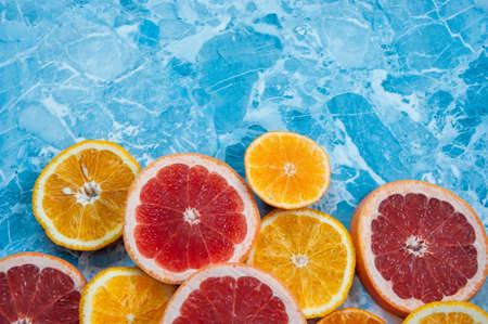 grapefruit, orange and tangerine on blue background. Citrus textureの写真素材