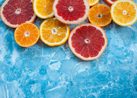 grapefruit, orange and tangerine on blue background. Citrus textureの写真素材