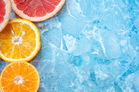 grapefruit, orange and tangerine on blue background. Citrus textureの写真素材