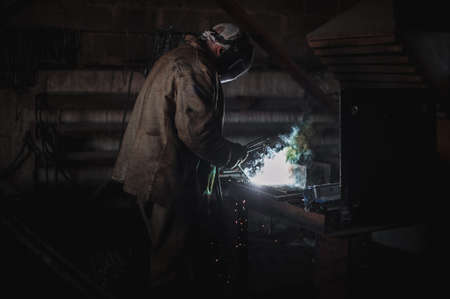 The job of a welder. A large concrete products plant and welding on it.の写真素材