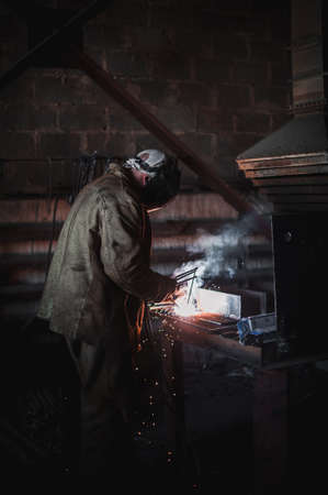 The job of a welder. A large concrete products plant and welding on it.の写真素材