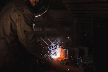 The job of a welder. A large concrete products plant and welding on it.の写真素材