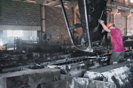 Workers pour wet cement in the forms. Production of concrete slabsの写真素材