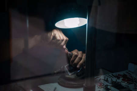 The jeweler behind the glass. Work with jewelry