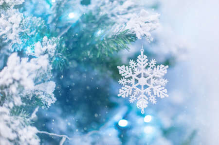 Christmas blue background with snowflakes. Decorative snowflake on Christmas tree