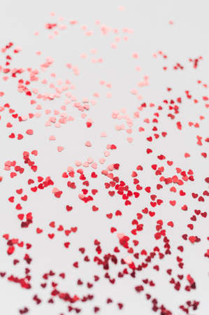a scattering of red hearts on a white background. Texture for Valentines dayの写真素材