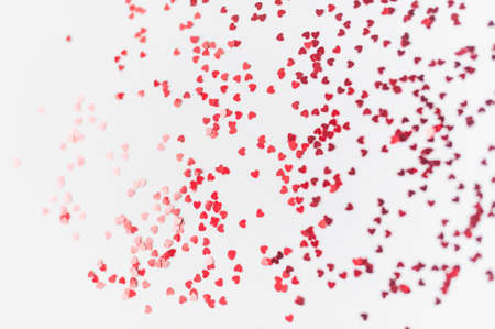 a scattering of red hearts on a white background. Texture for Valentines dayの写真素材