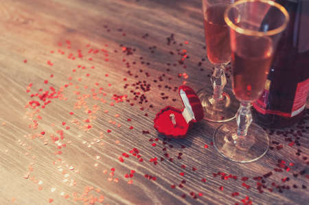 A red box with a ring, marriage proposal, Valentines Day, wine, romantic atmosphereの写真素材