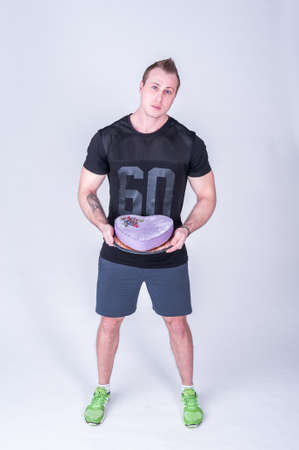 Young athlete with the cake. Healthy diet food. The concept of proper nutrition and healthy sweets.の写真素材