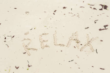 Inscription Zanzibar, Tanzania on the light sand on the beach at low tide.の写真素材