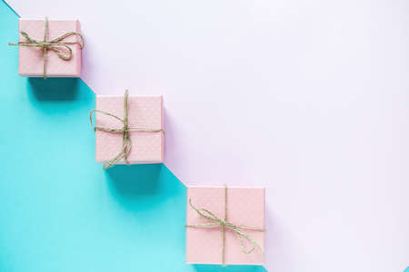 Gifts on pastel blue and pink background. Holidays concept. Flat lay, top view, copy space. Valentine's Day background. の写真素材